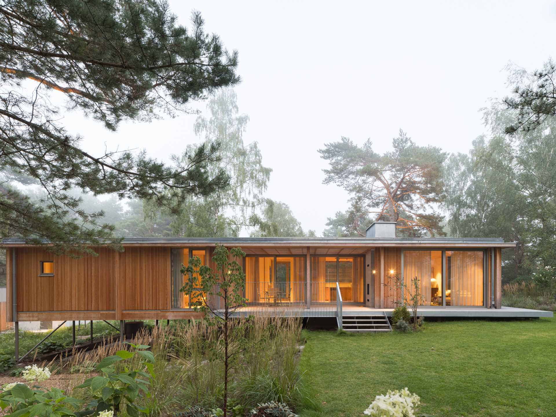 An elevated summer home clad in larch wood.