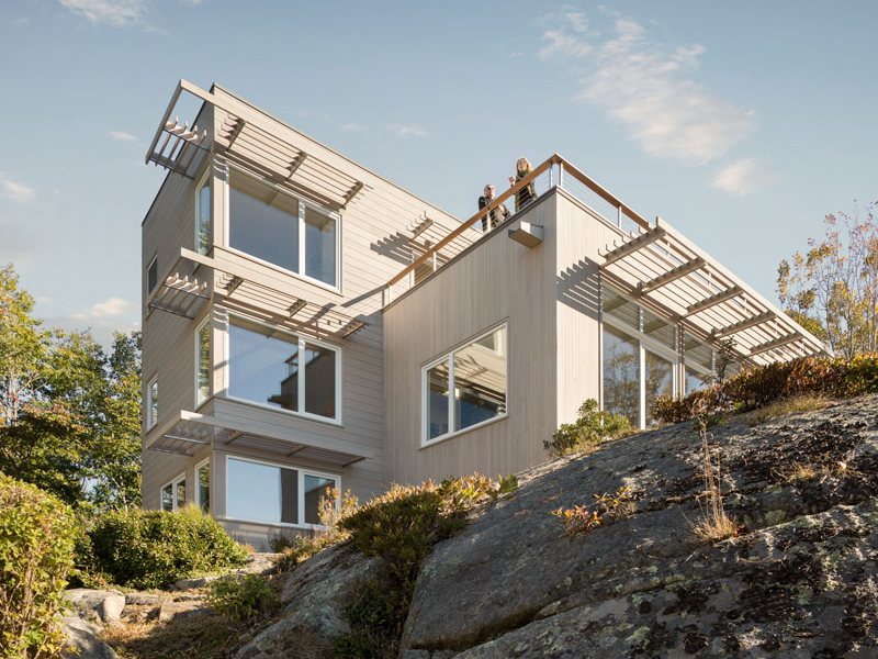 Discover a coastal home in Biddeford, Maine, perched on granite above a lily pond with breathtaking views of the Atlantic Ocean.