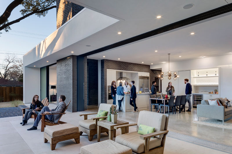 The backyard is a private retreat, with an outdoor patio nestled between the pool and the home. An original large tree offers natural shade, while the landscaping, designed to thrive in Texas heat, keeps the space inviting year-round.