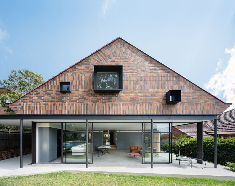 A dramatic gabled brick and glass addition brings light and scale to the family home.