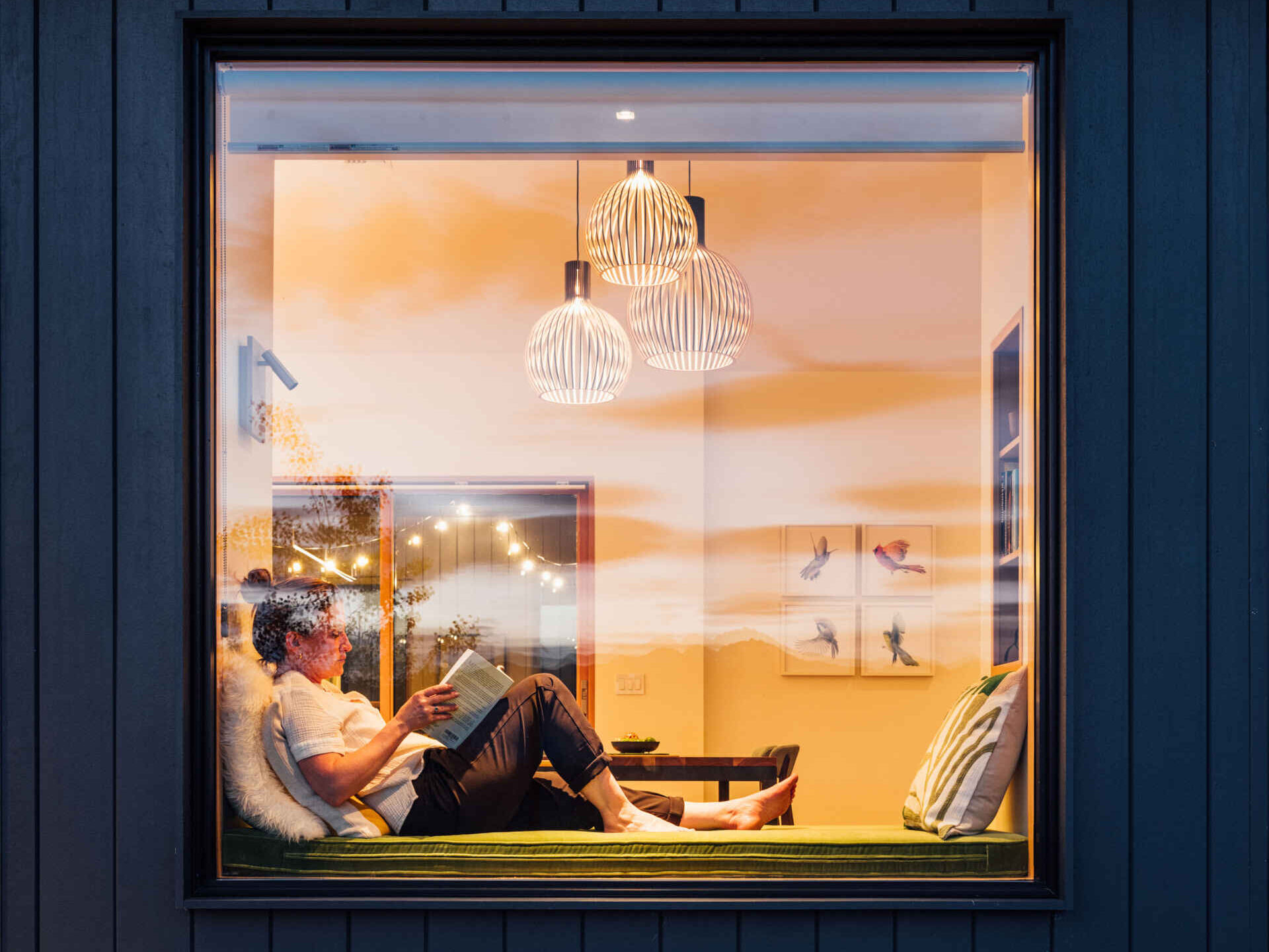A single built-in window seat captures the heart of this Washington home. Warm wood, soft cushions, and a perfectly framed mountain view make it the most irresistible place to pause and breathe.