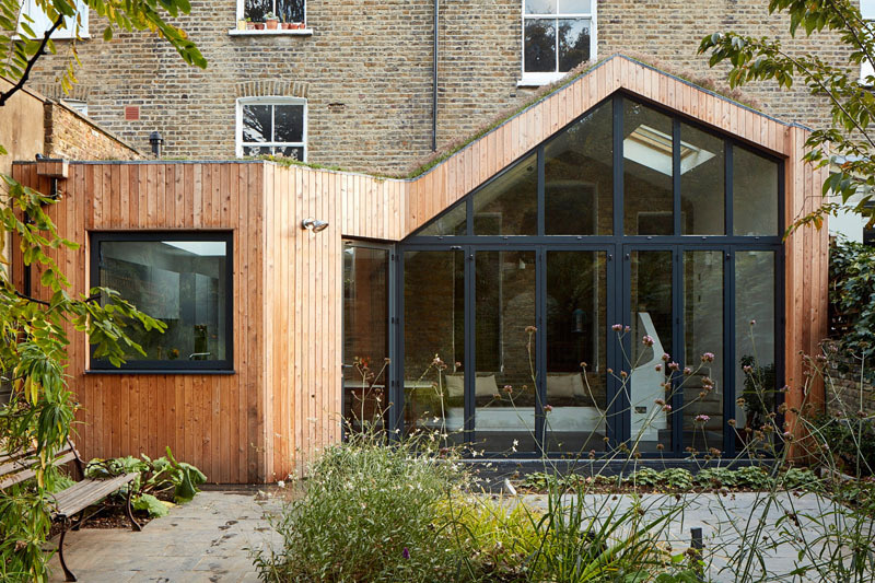A timber clad extension with a green roof replaces a failing conservatory with a warm and light filled space that connects beautifully to the garden.